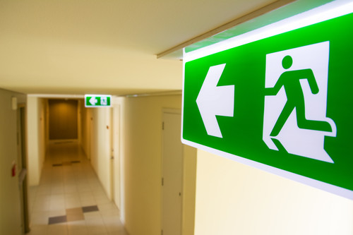 Fire exit sign at  the corridor in building.jpg