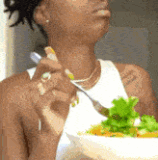 Pleased 02 Natural looking dark skinned Black woman eating a salad and enjoying it immensely aka Con.gif