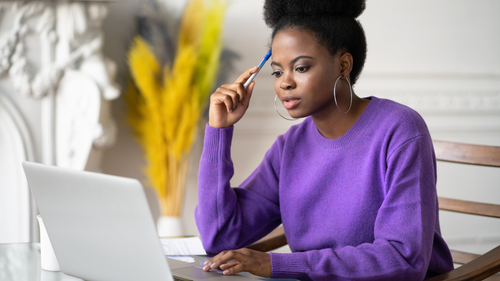 Young woman studying at her laptop