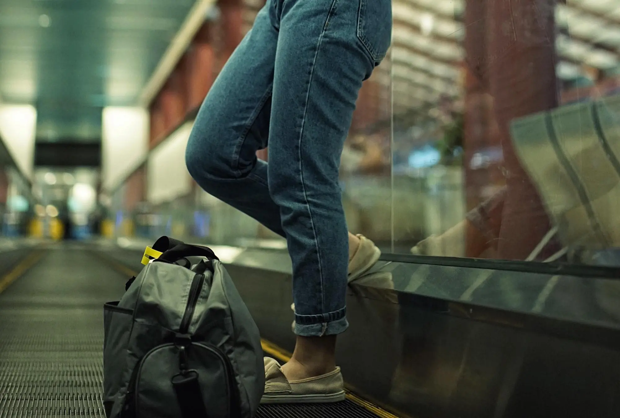 low section woman standing moving walkway