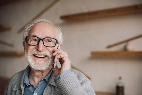happy bearded senior man talking by phone.jpg