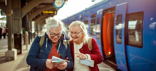 image of two senior women looking at a map at the train station.jpg