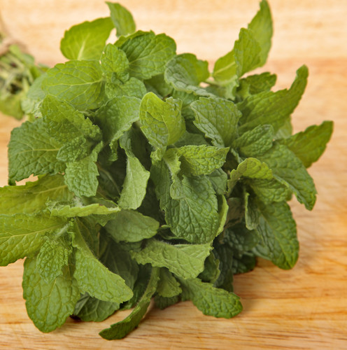 Bunch of fresh mint on an old wooden chopping board.jpg