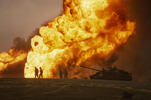 US Marines silhouetted against a burning oil well, Desert Storm 1991