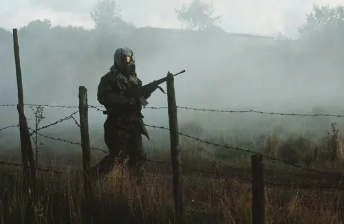 A USAF Security Policeman in his MOPP gear on patrol during Exercise Reforger 83. Sola Air Station, Norway, 19 Sept 1983