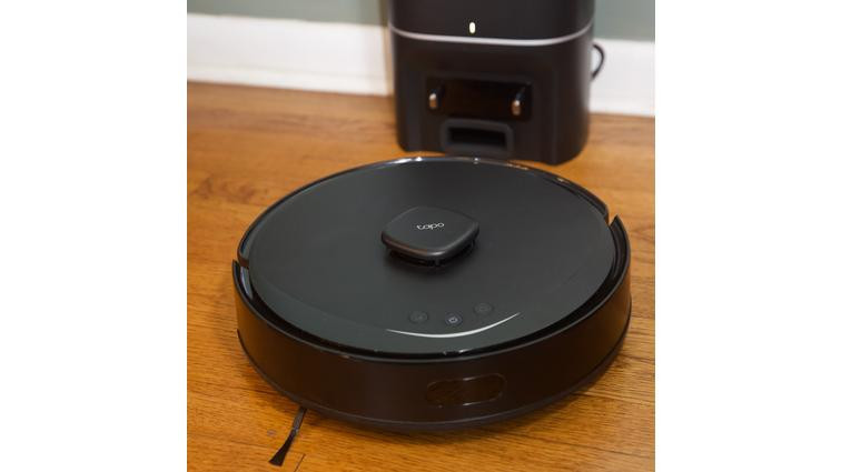 None A black robot vacuum on a hardwood floor