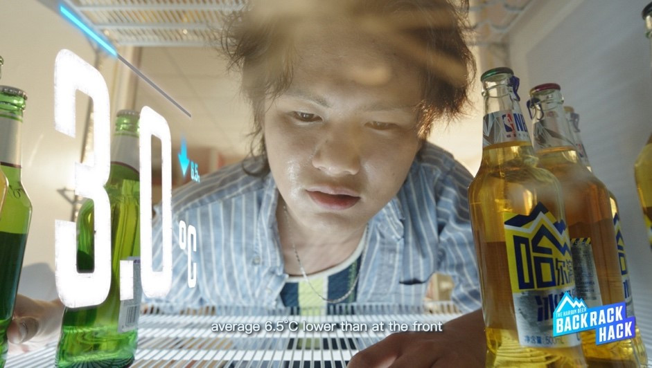A person looking at a bottleDescription automatically generated