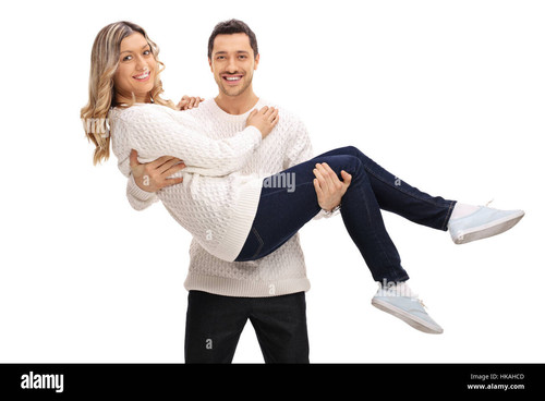 delighted guy holding a girl in his arms isolated on white background HKAHCD.jpg