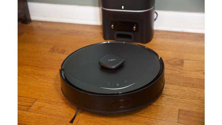 None A black robot vacuum on a hardwood floor