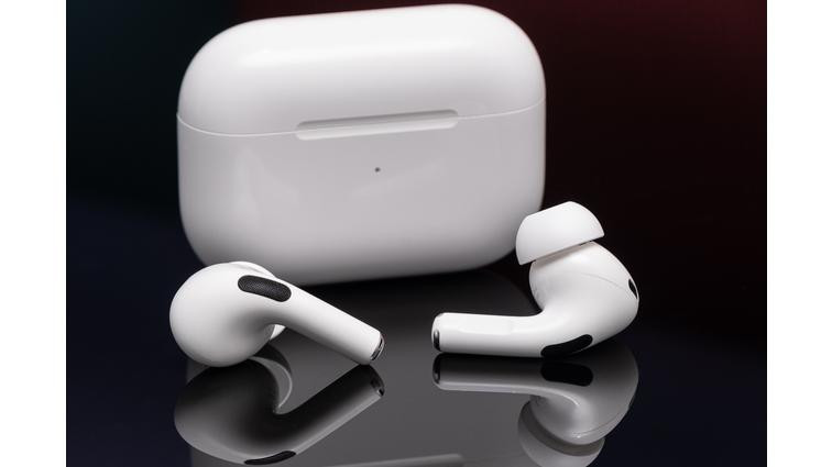 None Apple’s second-generation AirPods Pro photographed on a reflective black surface.