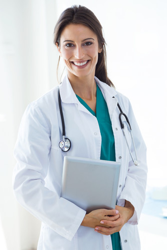 beautiful young female doctor looking camera office.jpg