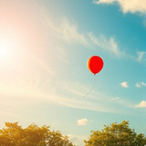 www.naked-ai.art - Red balloon flying in the sky