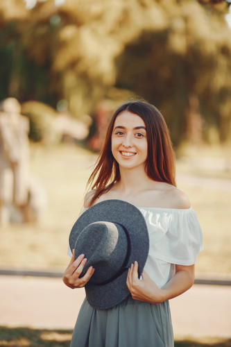 Beautiful and stylish girl in hats in a summer park.jpg