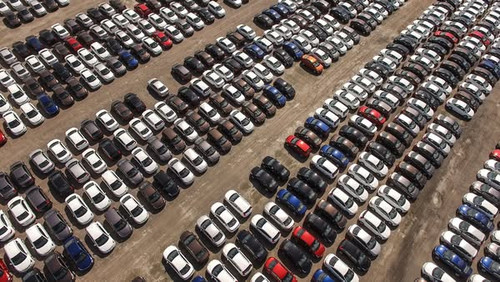 Aerial view of huge storage parking with new cars.jpg