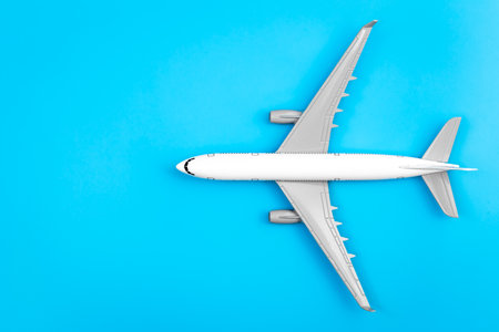 199960470 white plane airplane on a blue background flat lay copy space.jpg