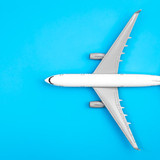 199960470 white plane airplane on a blue background flat lay copy space