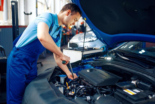 worker in uniform checks engine car service 63MWLXA 1000x675.jpg