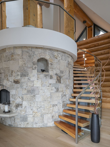 sunridge whistler curved staircase stone tower floating treads.jpg