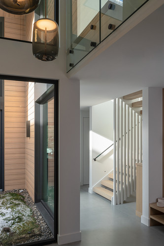 fitzsimmons residence whistler foyer double height glass pendant floating stairs.jpg