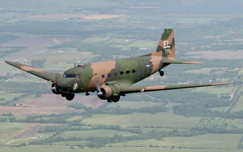 An AC 47 from Topeka, Kansas, conducts a gunship legacy flight during AirVenture Oshkosh 2021(croppe.jpg
