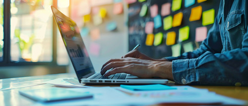 Business developer using Kanban board framework on laptop computer. Agile software development lean 