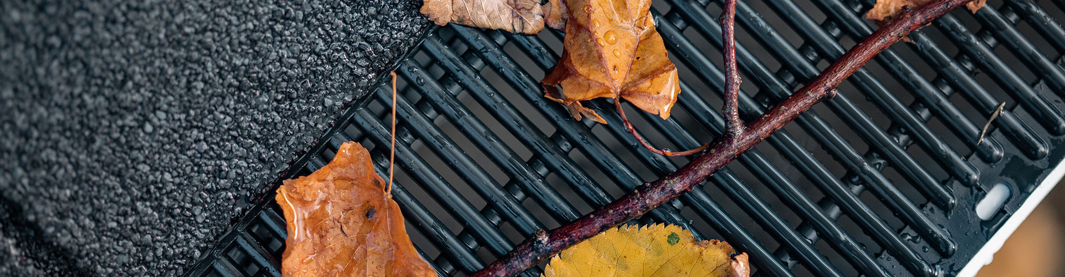 Leaves and debris on Raindrop gutter guard being blocked from entering gutters