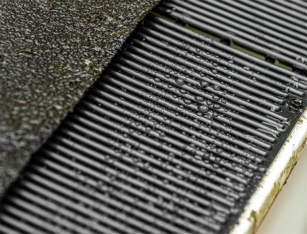 Water beading on Raindrop gutter guard surface showing self-cleaning design