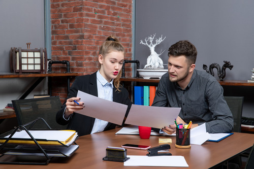 top view young busy motivated clerical workers discussing one issue documents office.jpg