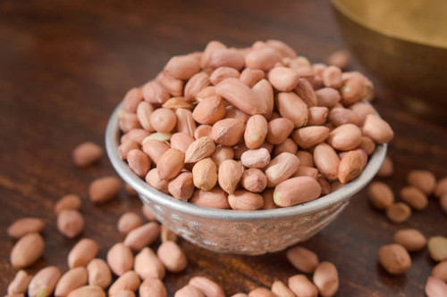 Peeled peanuts in a Silver bowl on wooden old Table. rustic style.jpg