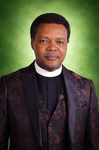 Confident clergyman in brocade tuxedo.png