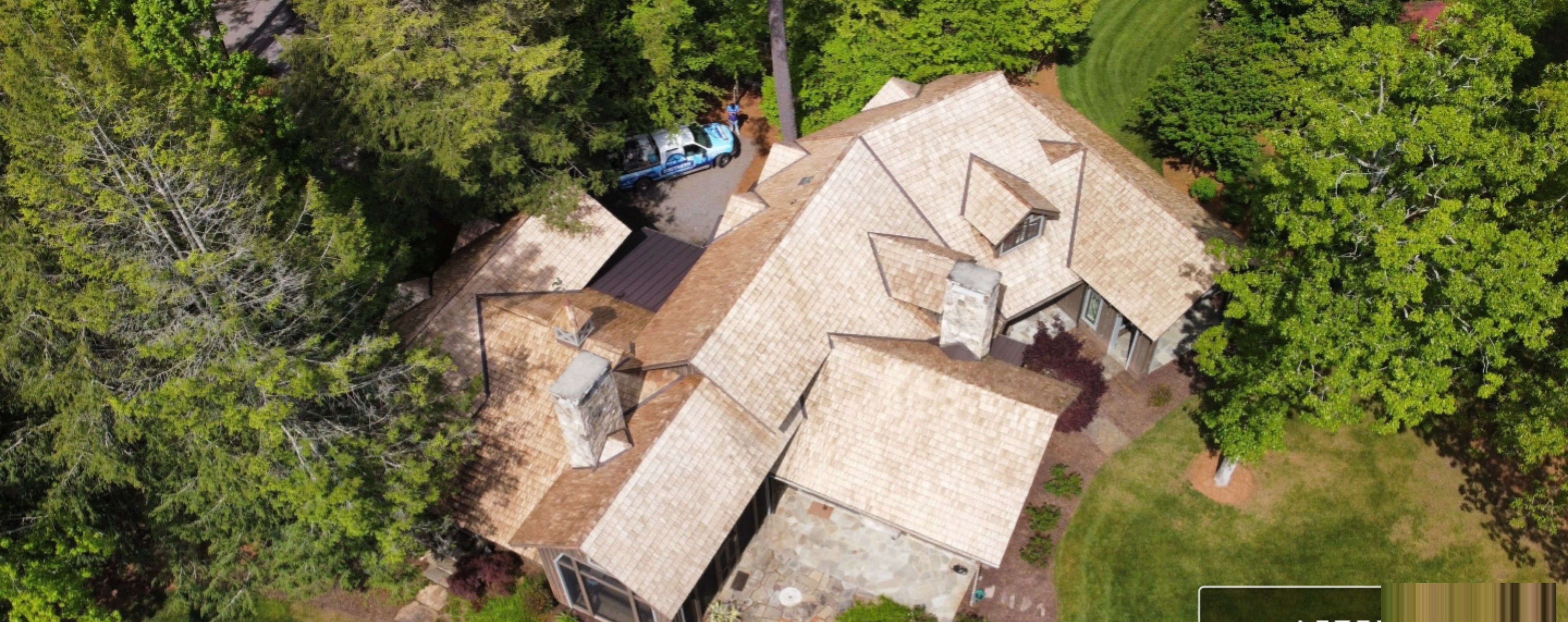 Cedar shake roof after professional soft wash — aerial view showing restored wood tone