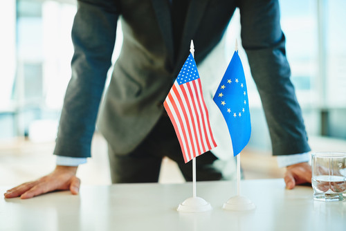 American flag and flag of European Union with businessman near by.jpg