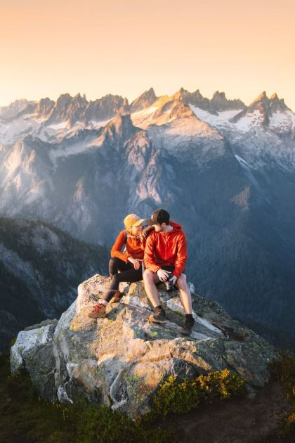 Love at the Edge: A Couple’s Quiet Moment Above the Mountains