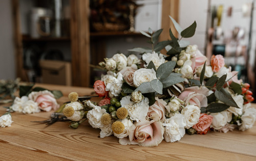 beautiful floral arrangement wooden table.jpg