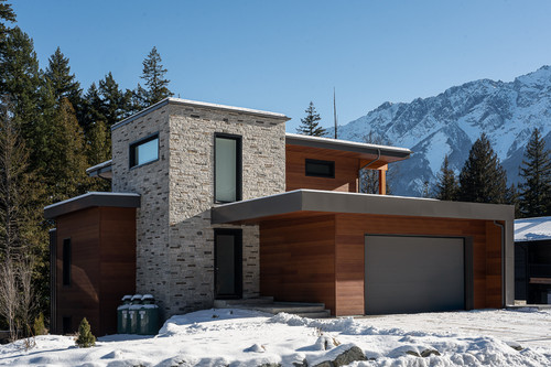 eagle residence pemberton exterior front stone wood mountain backdrop.jpg