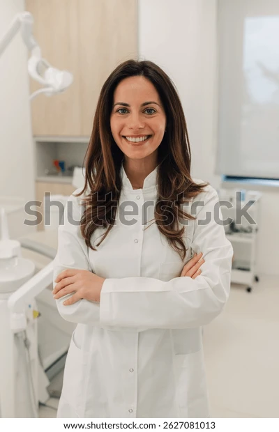 confident smiling dentist posing arms 600w 2627081013 (1).webp