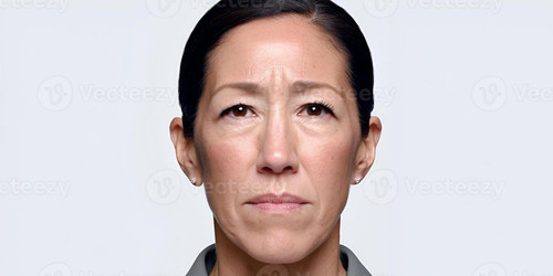a serious middle aged woman with dark hair shows prominent frown lines and forehead wrinkles photo 深.jpg