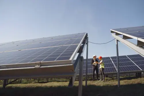 Electricians next to solar panels[2].webp