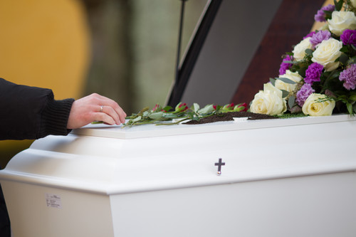 closeup shot person hand casket with blurred background.jpg