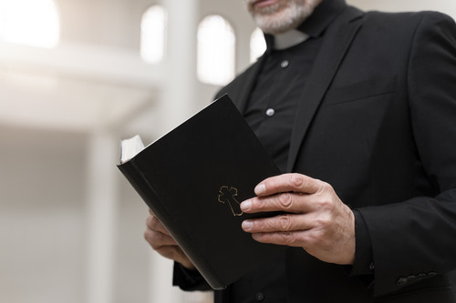 side view senior priest church with bible.jpg