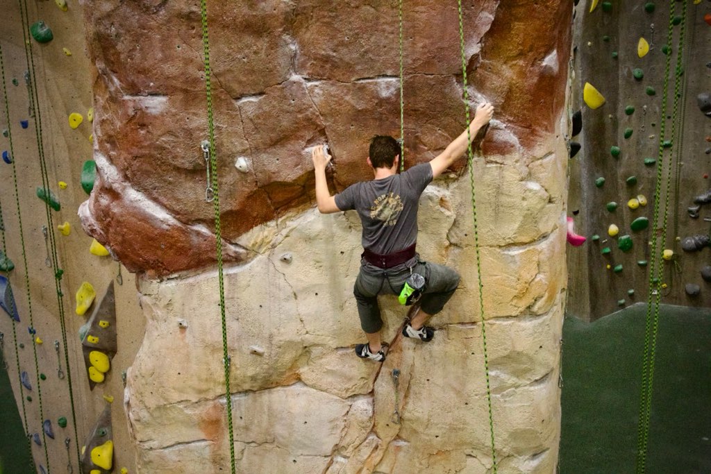 Community-focused indoor climbing experience with climbers gathering in the facility