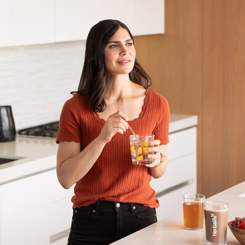 li woman drinking in kitchen.jpg