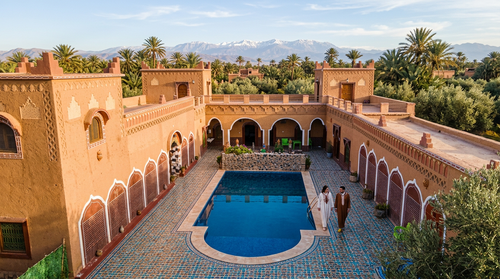 Firefly Gemini Flash Aerial view of a luxury traditional Moroccan Kasbah guesthouse, terracotta and .png