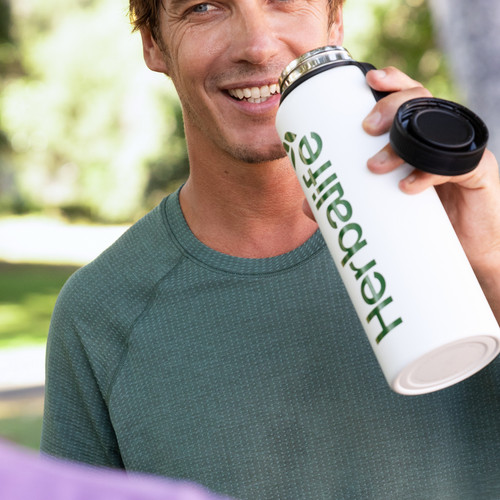 li man drinking protein shake park.jpg