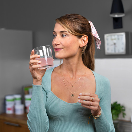 li woman drinking collagen drink.jpg