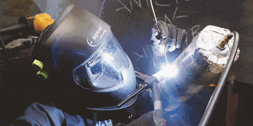 A skilled welder carefully connecting metal pipes.jpg