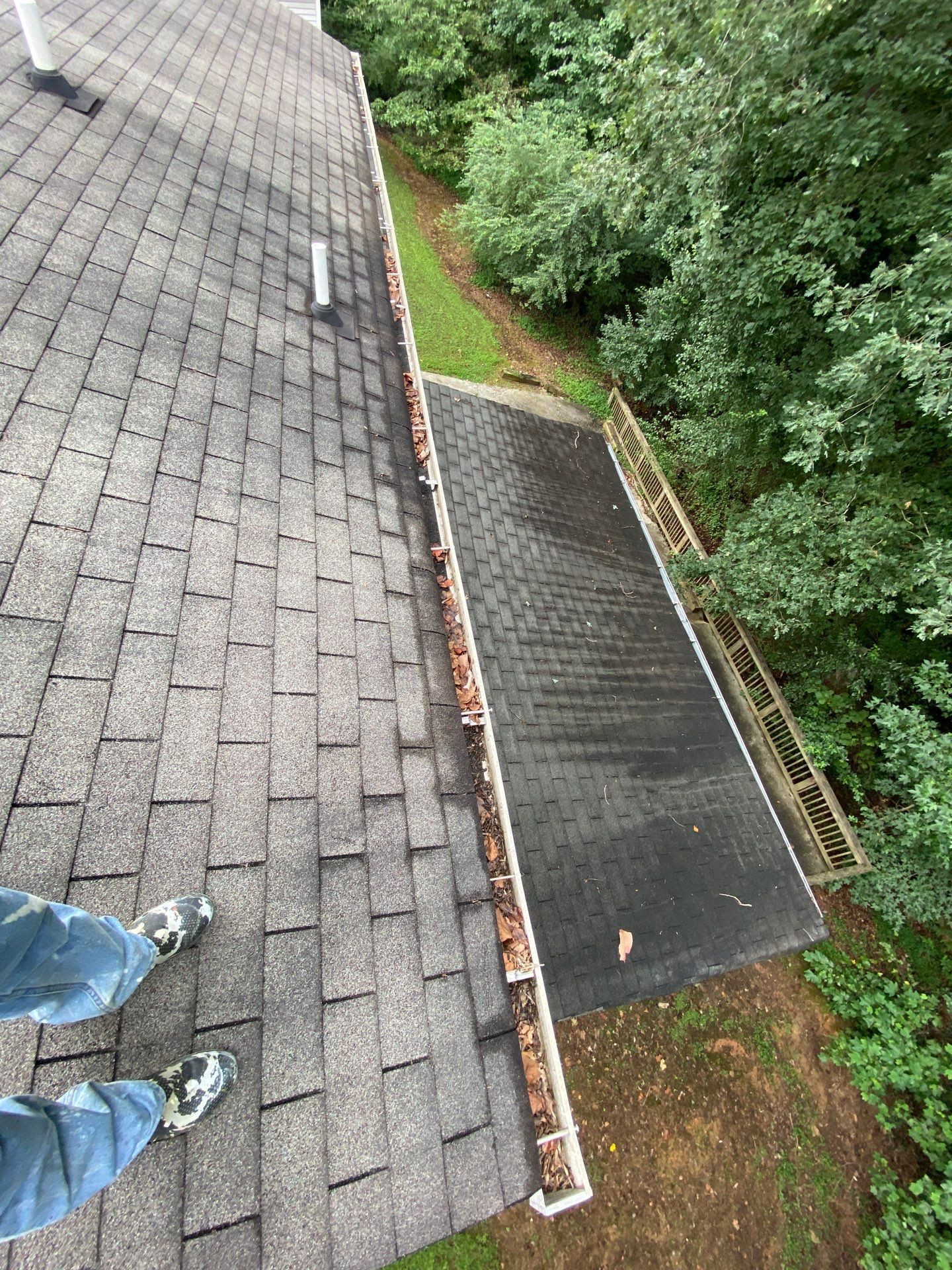 Gutters clogged with leaves on the same home before professional gutter cleaning