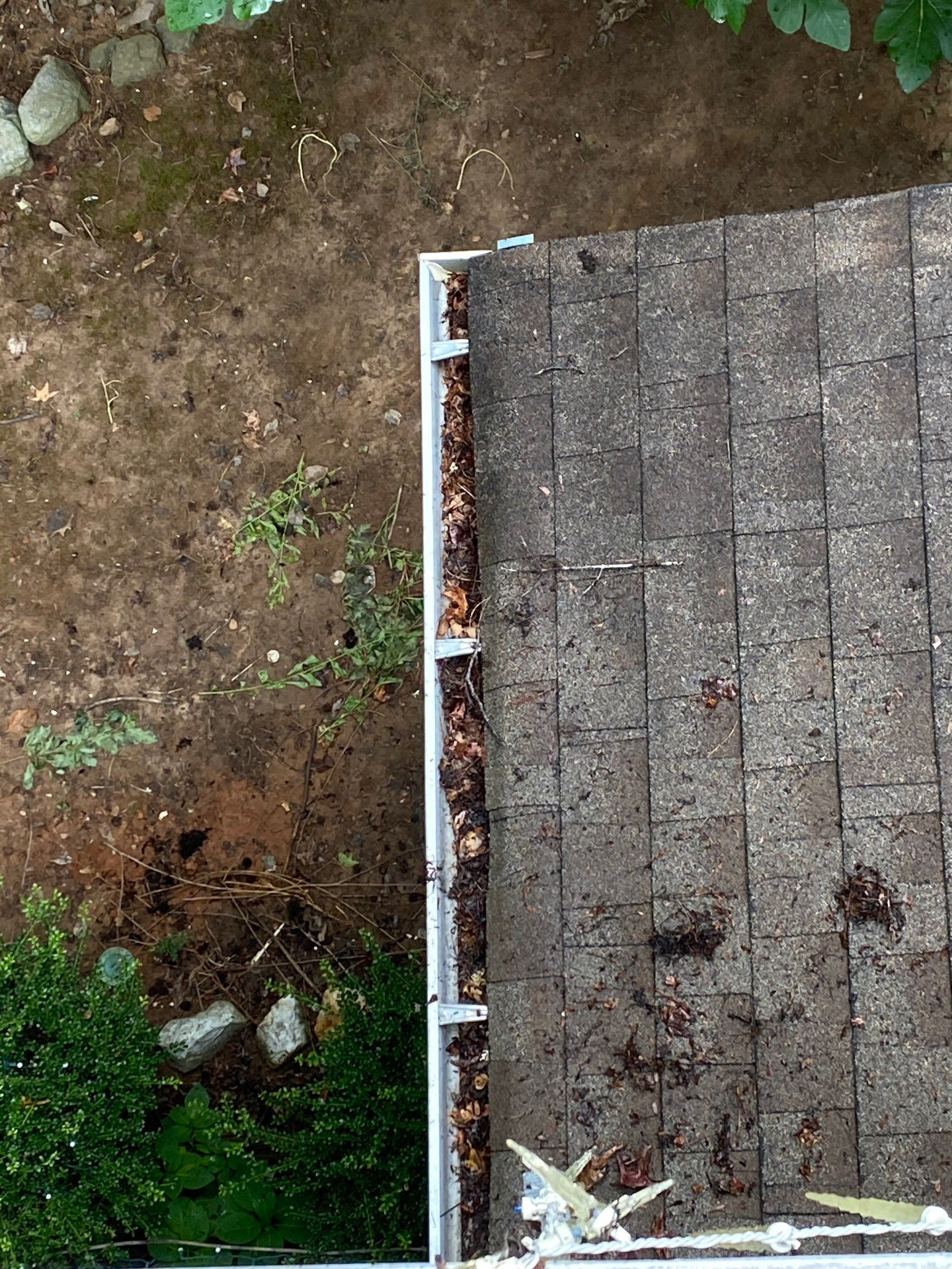 Close-up of gutter clogged with leaves and debris before professional cleaning in North Georgia