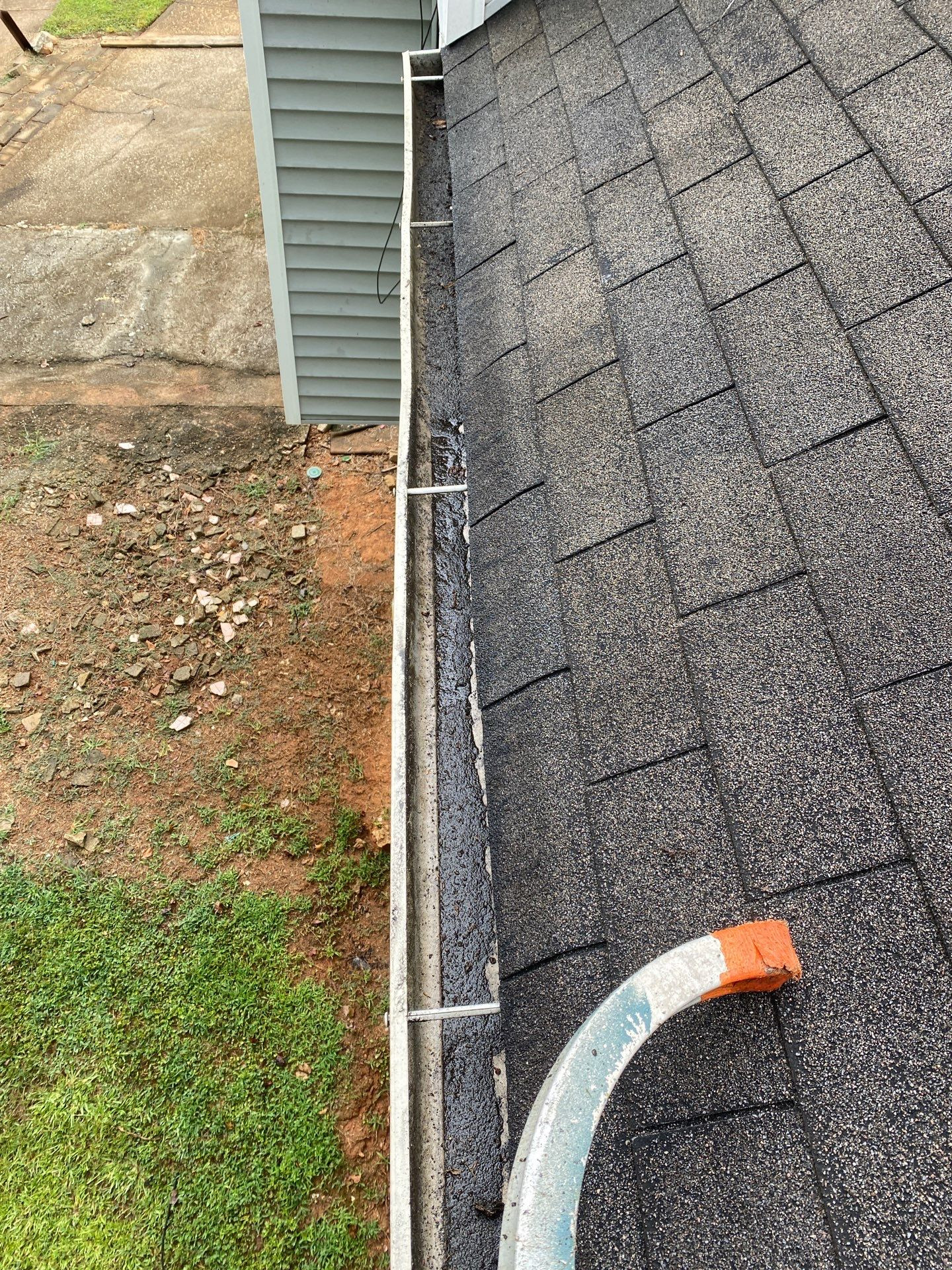 Clean gutter with downspout after professional gutter cleanout in North Georgia