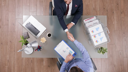 Top-view-businessmen-shaking-hands-business-negotiation-startup-office_482257-19402.jpg